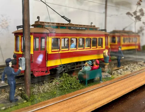 model of a red and yellow trolley